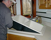 plumbing contractor installing a new kitchen sink